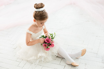 Image showing The little balerina in white tutu in class at the ballet school