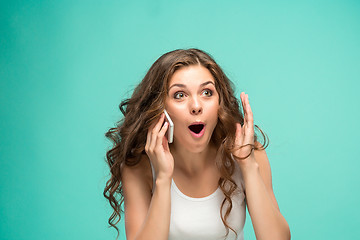 Image showing The portrait of disgusted woman with mobile phone