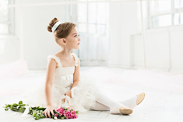 Image showing The little balerina in white tutu in class at the ballet school