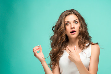 Image showing Frustrated young woman having a bad hair on blue