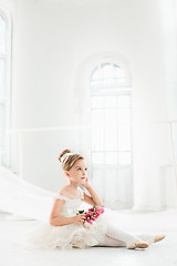 Image showing The little balerina in white tutu in class at the ballet school