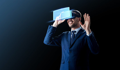 Image showing businessman in virtual reality headset over black