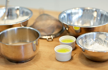 Image showing bowls with flour and egg whites at bakery kitchen