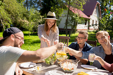 Image showing happy friends having dinner at summer garden party