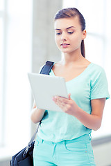 Image showing smiling student with tablet pc in college