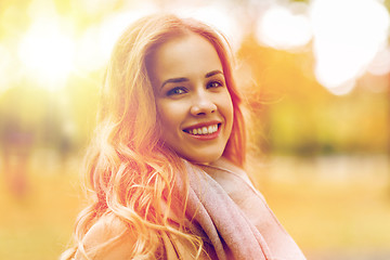 Image showing beautiful happy young woman smiling in autumn park