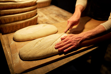 Image showing chef or baker with dough cooking bread at bakery