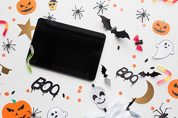 Image showing tablet pc, halloween party decorations and candies