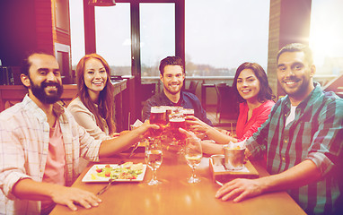 Image showing friends dining and drinking beer at restaurant