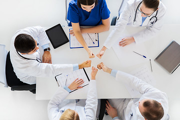 Image showing group of doctors showing thumbs up over table