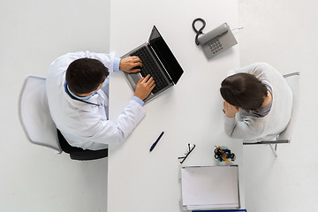 Image showing doctor with laptop and woman patient at hospital