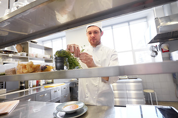 Image showing happy male chef cooking at restaurant kitchen