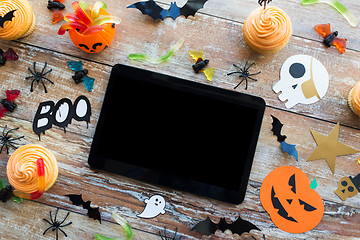 Image showing tablet pc, halloween party decorations and treats