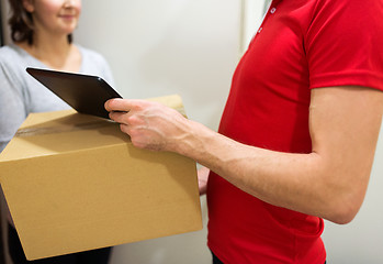 Image showing delivery man with box, tablet pc and customer