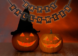 Image showing carved pumpkins and happy halloween garland