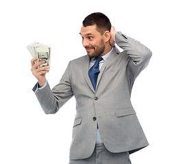 Image showing smiling businessman with american dollar money