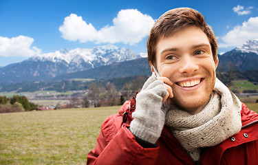 Image showing man calling on smartphone over alps mountains