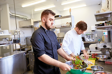 Image showing chef and cook cooking food at restaurant kitchen