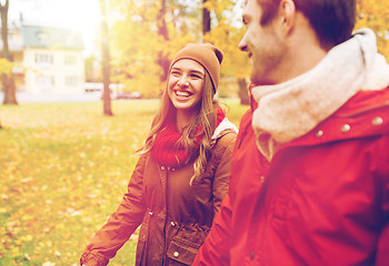 Image showing happy young couple walking in autumn park