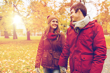 Image showing happy young couple walking in autumn park