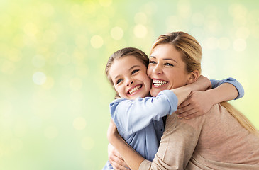 Image showing happy girl with mother hugging over lights