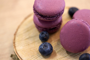 Image showing blueberry macarons on wooden stand