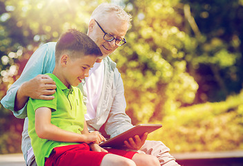 Image showing happy grandfather and boy with tablet pc outdoors