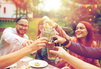 Image showing happy friends with drinks at summer garden party