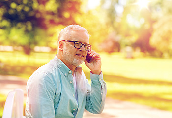 Image showing senior man calling on smartphone at summer park