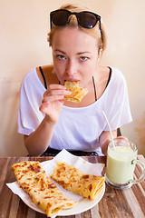 Image showing Woman eating traditional moroccan breakfast in coffee shop.