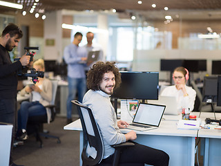 Image showing businessman working using a laptop in startup office