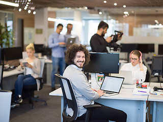 Image showing businessman working using a laptop in startup office