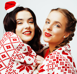 Image showing young pretty happy smiling blond and brunette woman girlfriends on christmas in santas red hat and holiday decorated plaid, lifestyle people concept