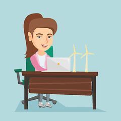 Image showing Caucasian worker of wind farm working on a laptop.