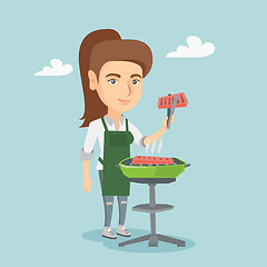 Image showing Caucasian woman cooking steak on the barbecue.