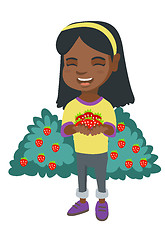 Image showing African girl holding fresh strawberries in hands.