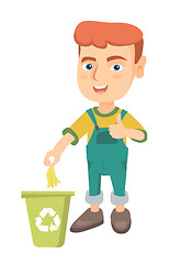 Image showing Little boy throwing banana peel in recycling bin.