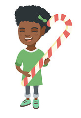 Image showing African little girl holding christmas candy cane.