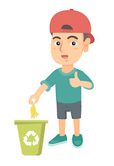 Image showing Little boy throwing banana peel in recycling bin.
