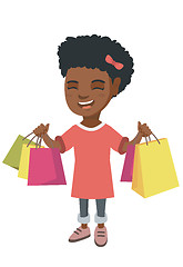 Image showing Happy african-american girl holding shopping bags.