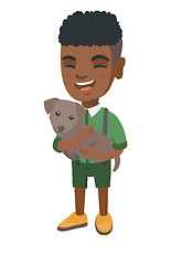 Image showing African-american happy boy holding a dog.