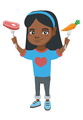 Image showing Little african girl holding fresh carrot and steak