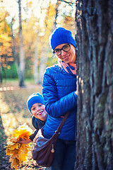 Image showing Beauty woman and her son at autumn park