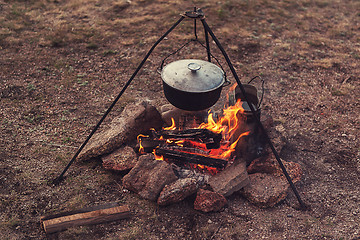 Image showing Preparing food on campfire