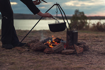 Image showing Preparing food on campfire