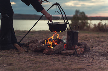 Image showing Preparing food on campfire