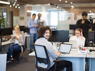 Image showing businessman working using a laptop in startup office