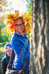 Image showing Beauty woman and her son at autumn park