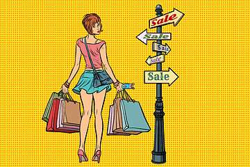 Image showing young woman at the sign for sales