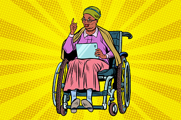 Image showing elderly African woman disabled person in a wheelchair, gadget ta